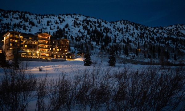Snowpine Lodge at dusk with snow in the background