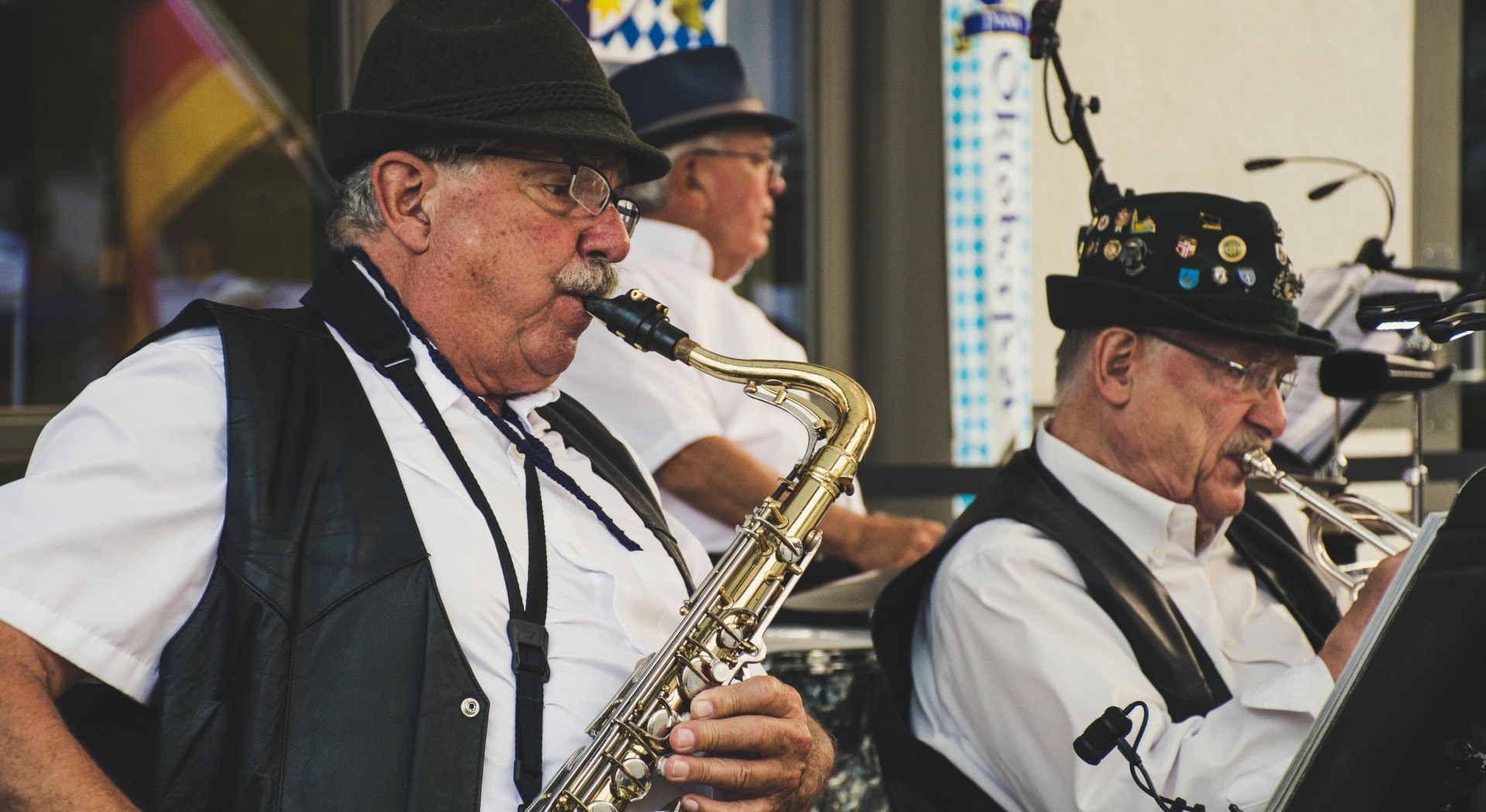 Musician playing a saxophone at an outdoor event.