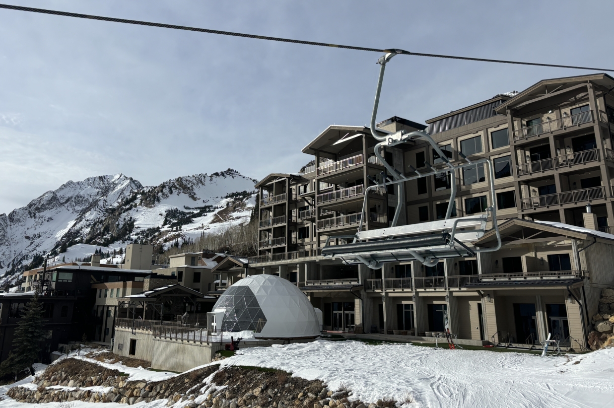 Exterior view of the lodge and ski lift infrastructure in winter.