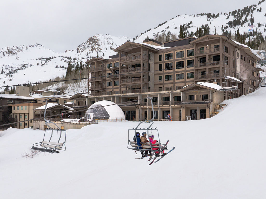 Exterior view of a large multi-story ski lodge in winter.
