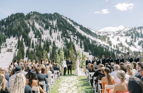 Outdoor wedding ceremony setup with rows of chairs facing the mountains.